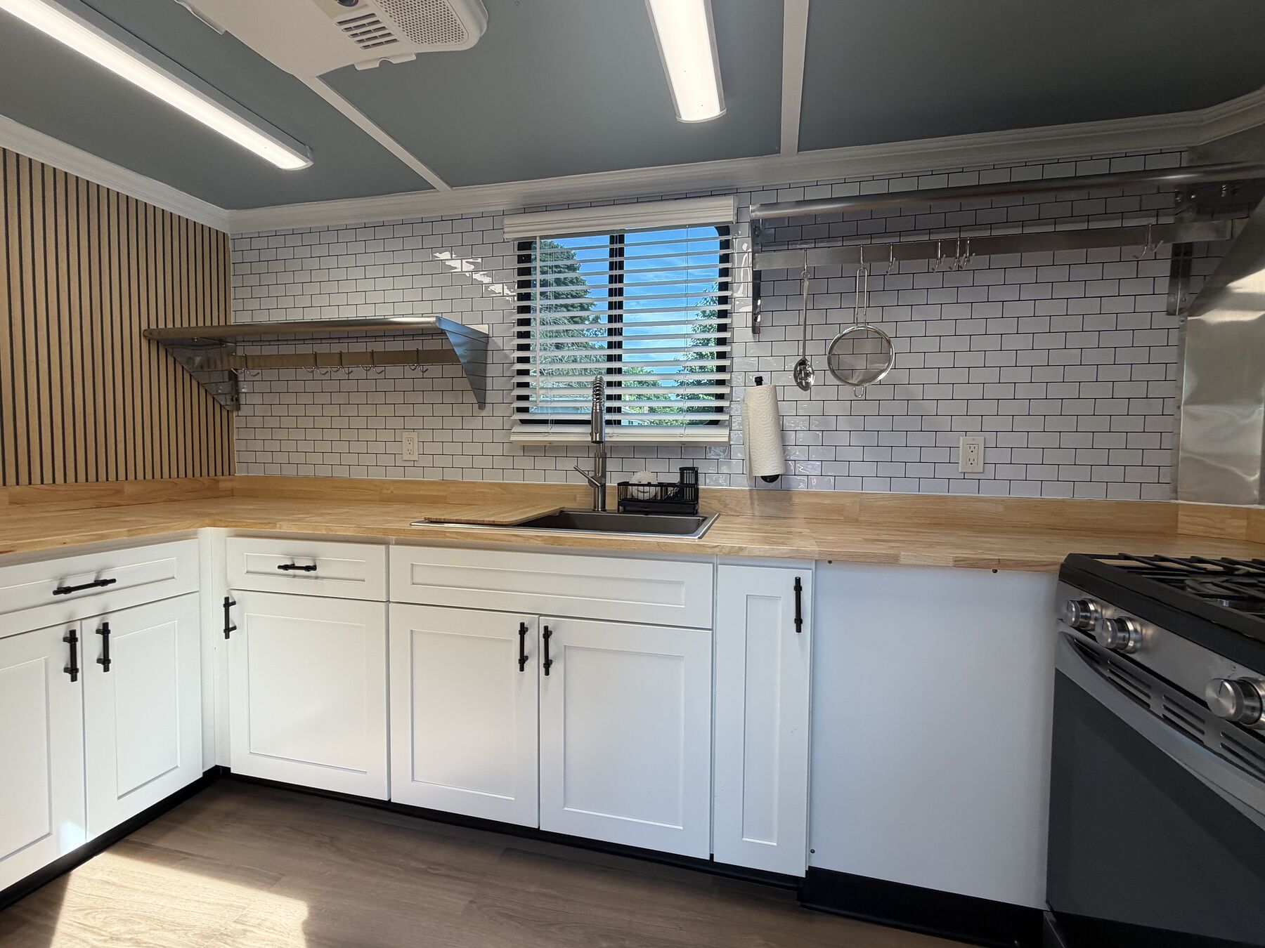 Inside the S&S kitchen trailer: butcher block counters, subway tile and a stainless gas range